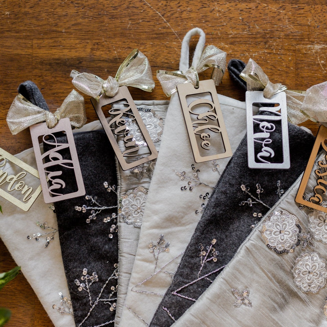 Personalized Wooden Stocking Tags, Script Font - Laser Cut Wood tags attached to stockings with ribbon- by LeeMo Designs in Bend, Oregon