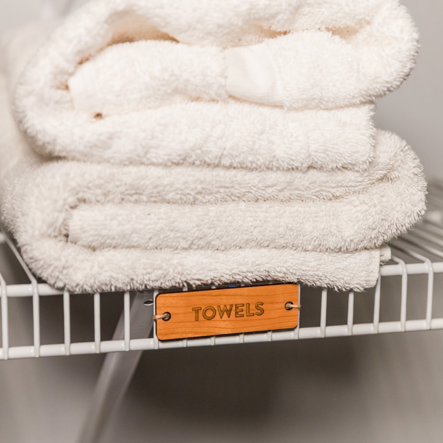 Tie-On Labels for Closet Organization - Cherry Wood Towels on ventilated wire shelving - by LeeMo Designs in Bend, Oregon