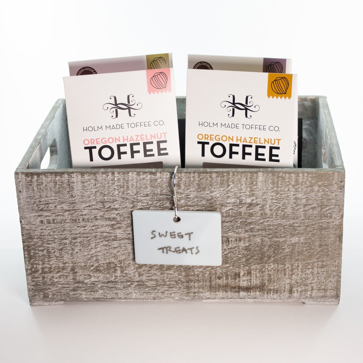 Dry-Erase Hooked Labels for Storage Bin Organization hanging from gray wood box with Holm Made Toffee- by LeeMo Designs in Bend, Oregon