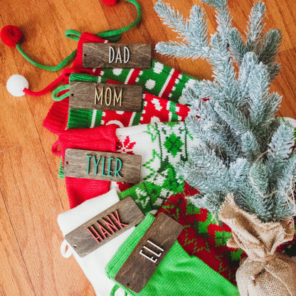 Personalized Wooden Stocking Tags, Modern Font - Dark Stained Laser Cut Wood with White, red, green, silver, gold lettering - by LeeMo Designs in Bend, Oregon