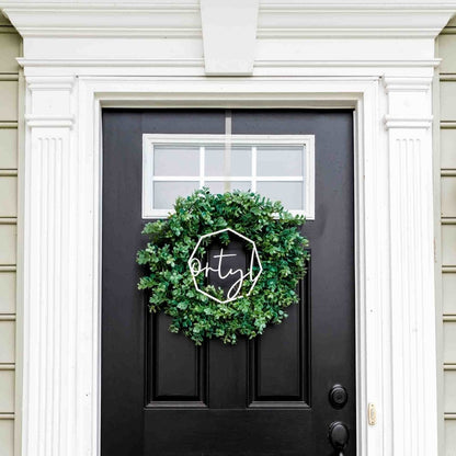Last Name Wreath Sign - in green wreath on black door by LeeMo Designs in Bend, Oregon