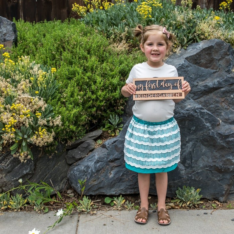 Reusable back-to-school wood sign - Cherry wood sign being held says "my first day of kindergarten" - By LeeMo Designs in Bend, Oregon